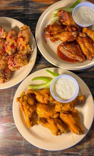 Table full of the best wings in Connecticut Dew Drop Inn Plates of the best Wings in Connecticut Dew Drop Inn